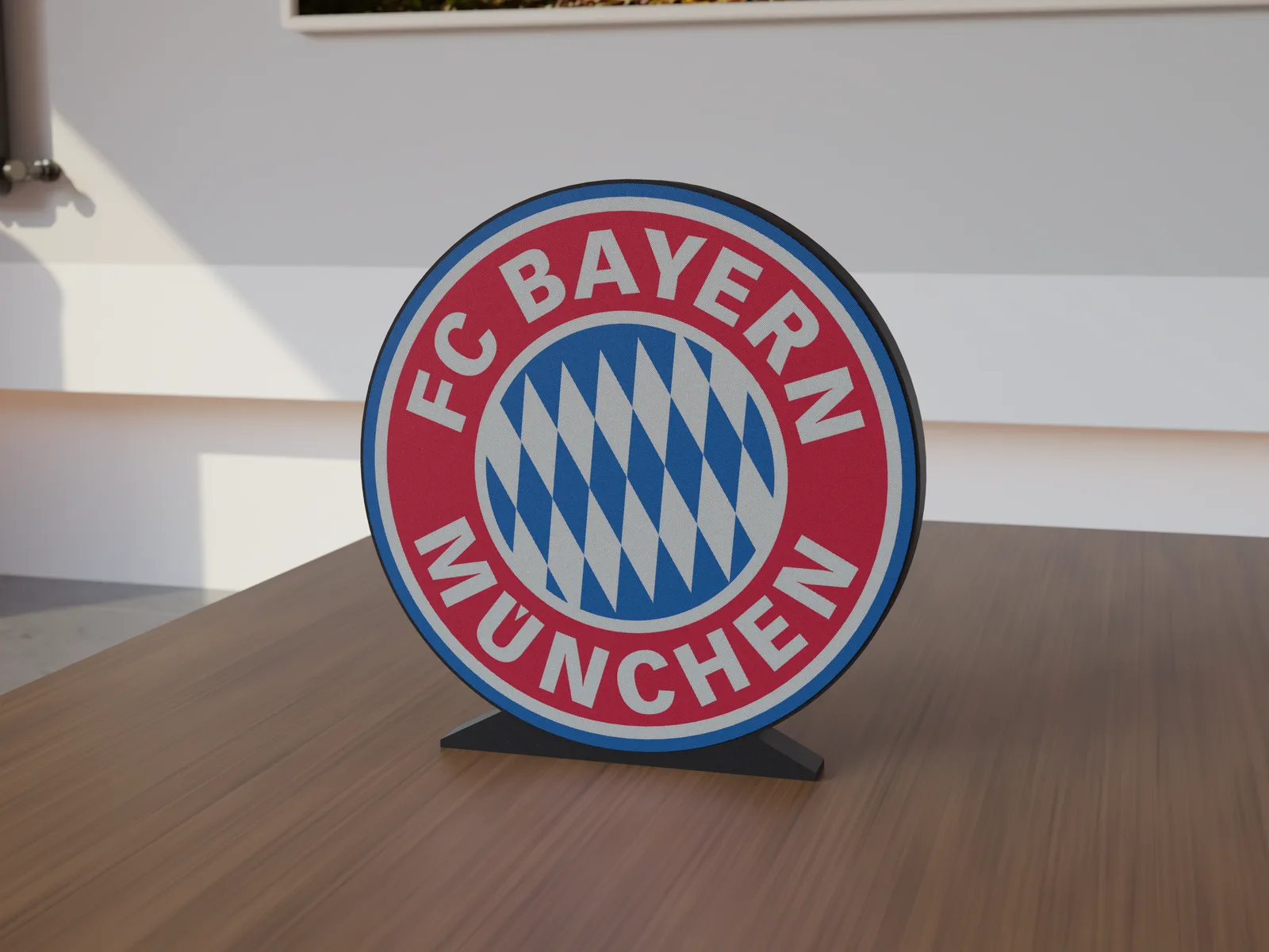 Freestanding 3D-printed logo sign, front view, 300mm size, standing on a wooden table.
