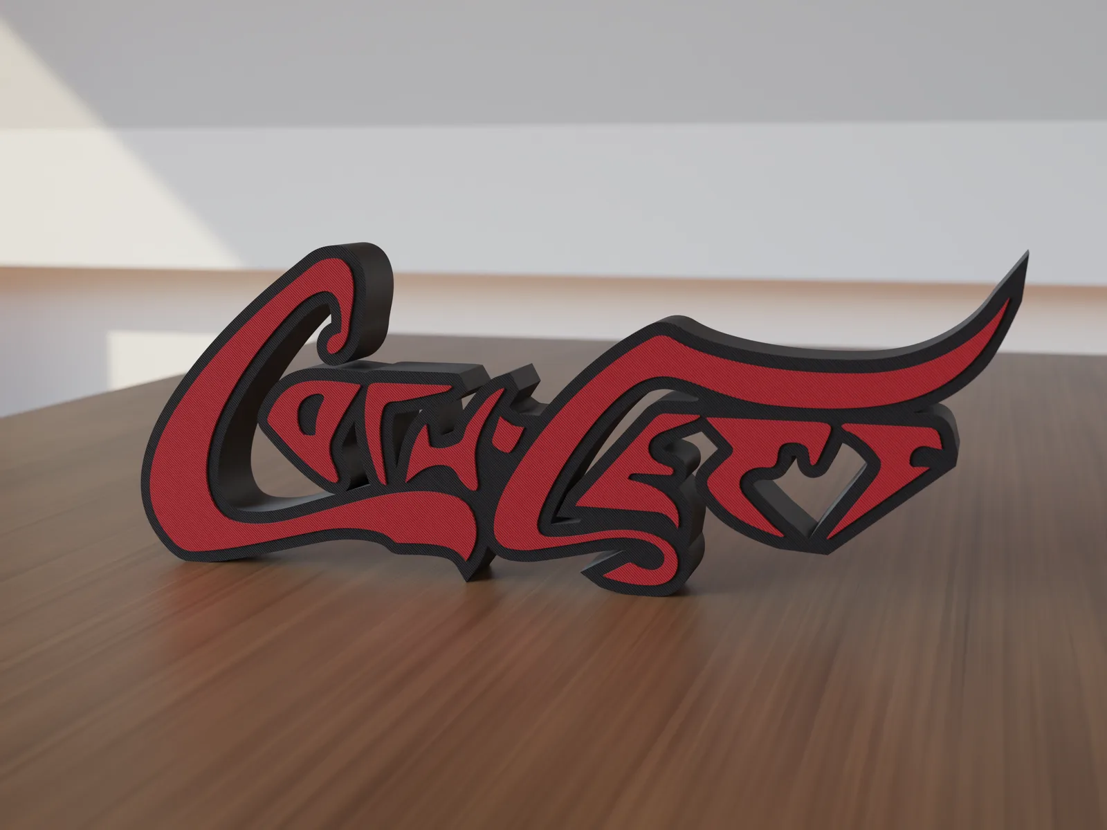Freestanding 3D-printed script logo sign, front view, black body with red script, 300mm size, standing on a wooden table.