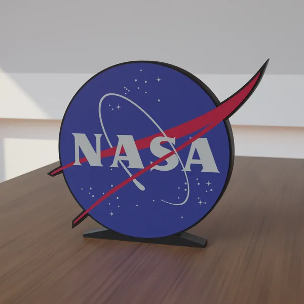 Freestanding 3D-printed logo sign, front view, 300mm size, standing on a wooden table.