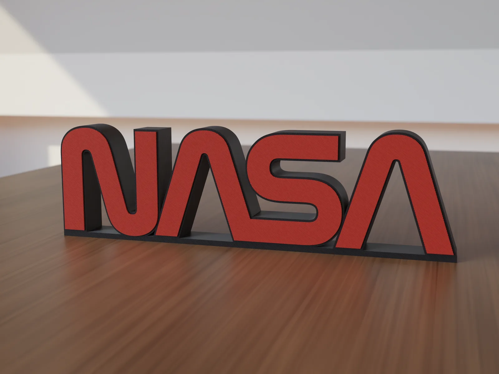 Freestanding 3D-printed logo sign, front view, 300mm size, standing on a wooden table.
