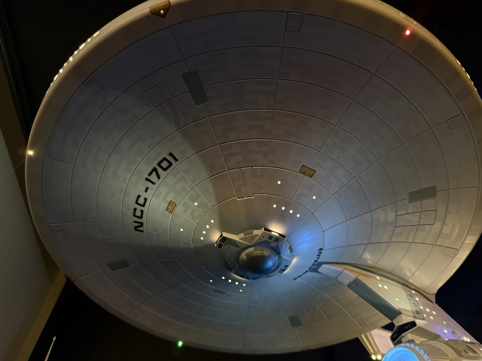 The underside of the saucer lit by the spotlights, throwing light across the registry markings.